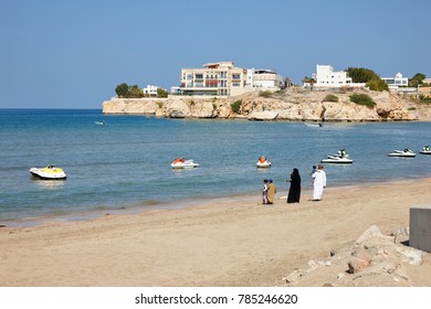 Arabian Family Walking On The Beach Of Muscat, Oman