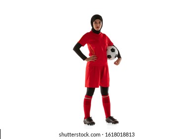 Arabian female soccer or football player isolated on white studio background. Young woman holding the ball, training, practicing in motion and action. Concept of sport, hobby, healthy lifestyle. - Powered by Shutterstock