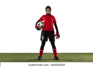 Arabian female soccer or football player, goalkeeper on white studio background. Young woman posing confident with ball, protecting goals for team. Concept of sport, hobby, healthy lifestyle. - Powered by Shutterstock