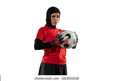 Arabian female soccer or football player, goalkeeper on white studio background. Young woman posing confident with ball, protecting goals for team. Concept of sport, hobby, healthy lifestyle. - Powered by Shutterstock