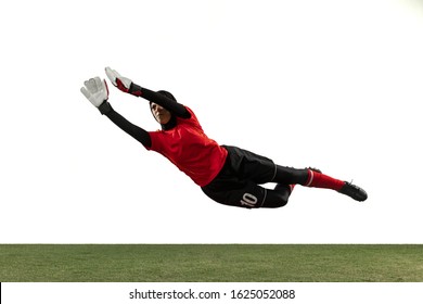 Arabian female soccer or football player, goalkeeper on white studio background. Young woman catching ball, training, protecting goals in motion and action. Concept of sport, hobby, healthy lifestyle. - Powered by Shutterstock