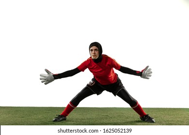 Arabian female soccer or football player, goalkeeper on white studio background. Young woman catching ball, training, protecting goals in motion and action. Concept of sport, hobby, healthy lifestyle. - Powered by Shutterstock