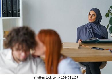 Arabian Girl Annoyed By Gossiping Couple And Looking Dissapointed. Muslim People Inclusion And Local Culture.