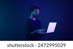 Arabian Indian man guy male programmer coder internet computer developer businessman business guy gamer hold laptop computer invite come here welcome nod head invitation work in violet neon background