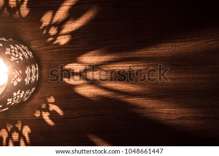 Arabian lantern on wooden floor. Eid lamp or lantern for Ramadan and other Islamic Muslim holidays, with copy space for text