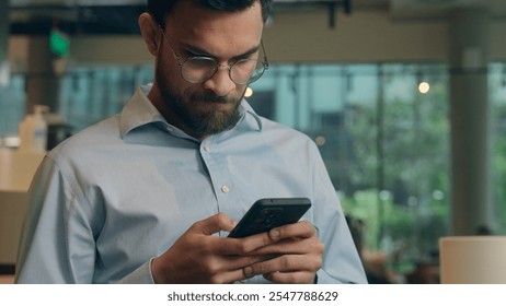 Arabian man ethnic guy upset worried frustrated businessman male business employer worker freelancer visitor reading mobile phone screen receive bad message cellphone notification sad anxious in cafe - Powered by Shutterstock