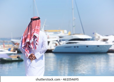 Arabian Man Looking At The Yacht Harbor, Back View