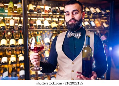 Arabian Man Sommelier Appreciating Drink In Lux Hotel