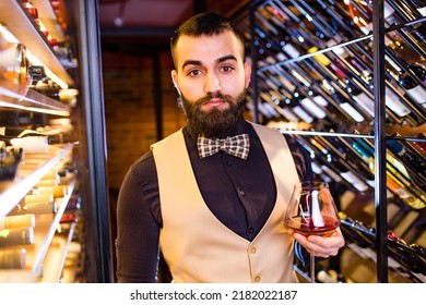 Arabian Man Sommelier Appreciating Drink In Lux Hotel