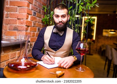 Arabian Man Sommelier Appreciating Drink In Lux Hotel