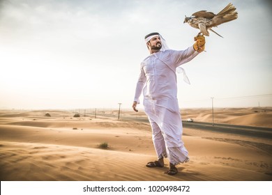 Arabian man walking  in the desert at sunrise - Powered by Shutterstock