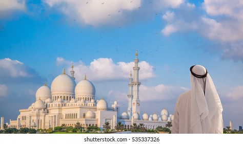 Arabian man watching Sheikh Zayed Grand Mosque in Abu-Dhabi, United Arab Emirates