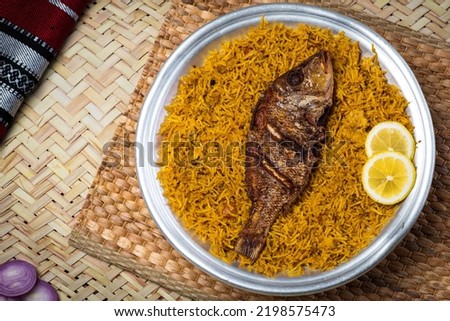 Arabian Sheri fish Kabsa rice with lemon slice served in dish top view of middle east food