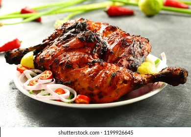 Arabian spicy food concept - homemade  tandoori chicken served with salads.