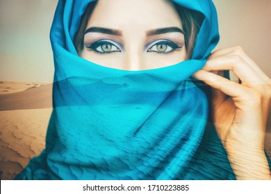 Arabian woman in the blue scarf closeup on the desert background. Double exposure.