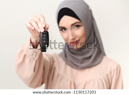 Arabian woman with car keys, selective focus
