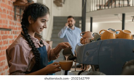 Arabian woman girl waitress barista in apron making cup fresh coffee in cafeteria indian female waitstaff service staff bartender serving customers make hot cappuccino bar counter in cafe restaurant - Powered by Shutterstock