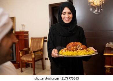 Arabian woman  holding rice and chicken during ramadan, Arabian mother with hijab preparing food  - Shutterstock ID 2179975663
