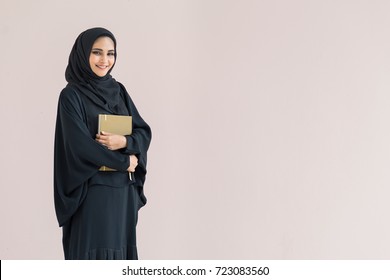  Arabian Woman Standing And Holding A Book.