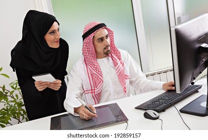 Arabic Business Couple Working In Office Using Tablet And Computer.