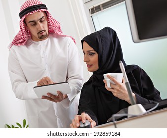 Arabic Business Couple Working In Office Using Tablet And Computer.