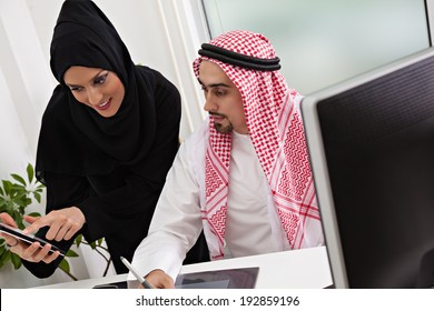 Arabic Business Couple Working In Office Using Tablet And Computer.