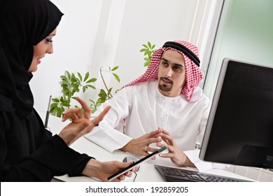 Arabic Business Couple Working In Office Using Tablet And Computer.