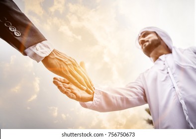 Arabic businessman giving an handshake to his business partner