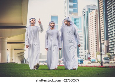 Arabic businessmen walking and talking in Dubai