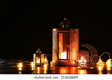Arabic candle holder with glowing fanoos lamps on dark background