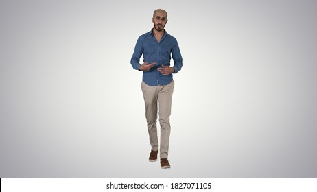 Arabic Casual Man Walking And Talking To Camera On Gradient Back