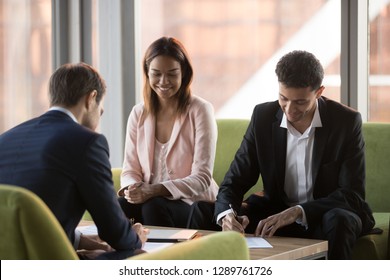 Arabic And Caucasian Business Partners Parties Signing Two Contracts At Multi-ethnic Meeting, Diverse Businessmen In Suits Making Investment Agreement Deal Fill Document Put Signature On Legal Papers