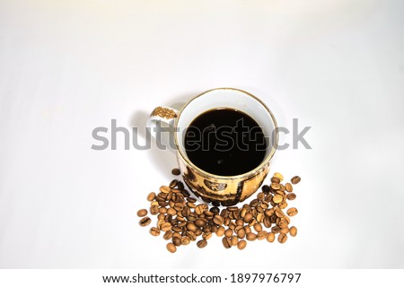 Arabic coffee beans bottom of coffee pot and cooked caffe inside the coffee pot isolated background.