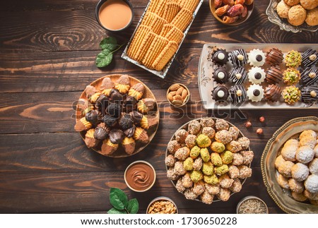 Arabic Cuisine; Cookies for celebration of El-Fitr Islamic Feast.(The Feast that comes after Ramadan). Varieties of Eid Al-Fitr sweets(kahk,biscuits, petit four). Top view with copy space.