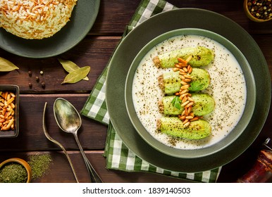 Arabic Cuisine; A delicious Lebanese stuffed zucchini in tangy garlic yogurt sauce. Served with cooked rice with vermicelli and topped with crispy pine nuts.