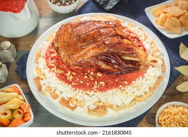 Arabic Cuisine; Egyptian oriental Fattah with white rice and crispy bread topped with seasoned garlic red sauce, crispy fried garlic and beef shank.