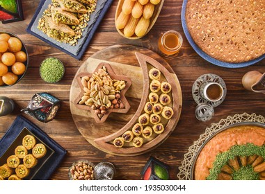 Arabic Cuisine: Middle Eastern desserts. Delicious collection of Ramadan traditional desserts. Served with tasty nuts, Arabic coffee, honey syrup and sugar syrup .Top view with close up. - Shutterstock ID 1935030044