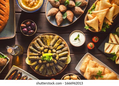 Arabic Cuisine;  Middle Eastern Traditional Dishes And Assorted Mezze Or Meze. Vine Leaves, Kibbeh, Spring Rolls, Sambusak, Kibbeh Nayyeh, Makdous, Haloumi Cheese, Olives,hummus And Yogurt Salad.