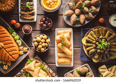 Arabic Cuisine;  Middle Eastern Traditional Dishes And Assorted Mezze Or Meze. Vine Leaves, Kibbeh, Spring Rolls, Sambusak, Kibbeh Nayyeh, Makdous, Haloumi Cheese, Olives,hummus And Yogurt Salad.