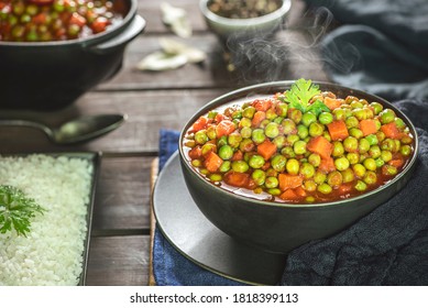 Arabic Cuisine; Middle Eastern traditional peas and carrot stew. A delicious vegan meal with peas and carrot doused in aromatic tomato sauce. Served with white rice and oriental pickles.