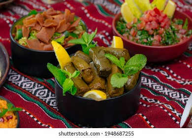 Arabic Cuisine; Middle Eastern traditional dishes and assorted mezze or meze. Vine leaves and salad.