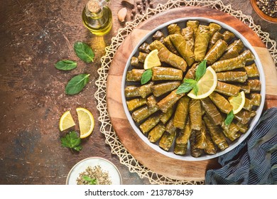 Arabic Cuisine; Traditional delicious stuffed vine leaves. Served with yogurt salad and fresh lemon. Top view with copy space. - Shutterstock ID 2137878439