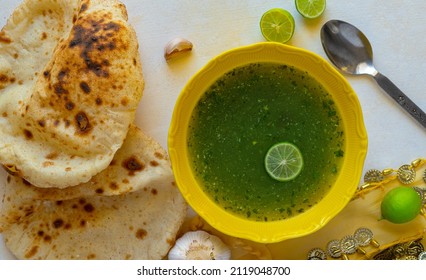 Arabic Cuisine. Traditional Molokhia Soup With Pita Bread On A Light Background. Flat Lay, Top View. Moroheiya And Flatbread, Lime