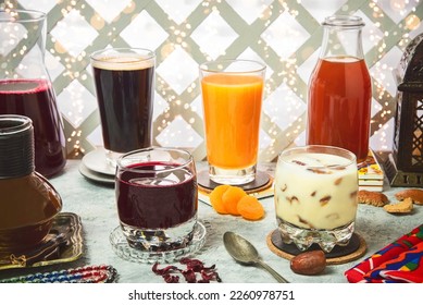 Arabic Cuisine; A variety of oriental Arabic drinks that are served in the month of Ramadan. They are delicious juices made from apricots, carob, licorice, doum palm and dates with milk. - Shutterstock ID 2260978751