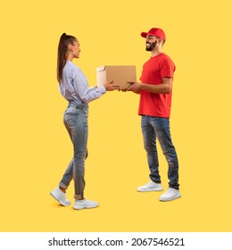 Arabic Delivery Guy Delivering Parcel To Customer Giving Cardboard Box To Young Woman Standing In Studio Over Yellow Background. Transportation And Shipping. Full-Length, Square