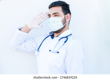 Arabic Doctor Doing Military Salute While Wearing Mask On His Face