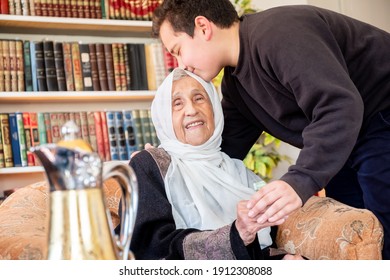 Arabic family enjoy eid celebration with grandmother while laughing together - Powered by Shutterstock