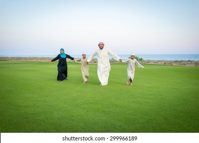 Arabic Family On Green Meadow In Nature