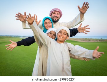 Arabic Family On Green Meadow In Nature