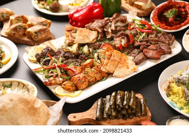 Arabic grilled arabic food dishes kebab, dolma, mansaf, shawarma
Turkish and Arabic Traditional Ramadan Mix Vali Kebab Plate inside Adana, Urfa, Chicken, Lamb, Liver and Beef on bread on table 
